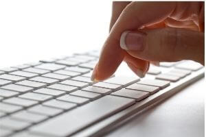 Photo of a woman's hand on a  keyboard