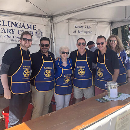 Photo of Amir Zahedani with Rotarians at a street fair in Burlingame, CA