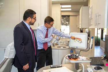 Dr. Choi shows Amir Zahedani the latest technology.